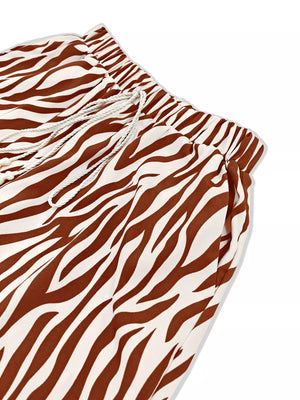 Brown zebra print lounge pants with drawstring waist and pockets.