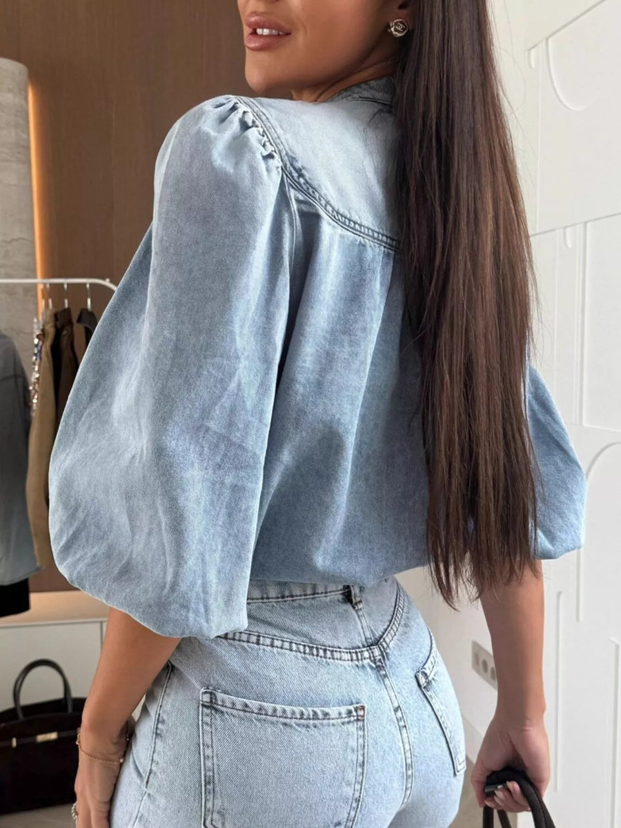 Denim button-down blouse in sky blue with puff sleeves and a casual style.