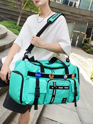 Green duffel bag with multiple pockets and black strap with text detail.