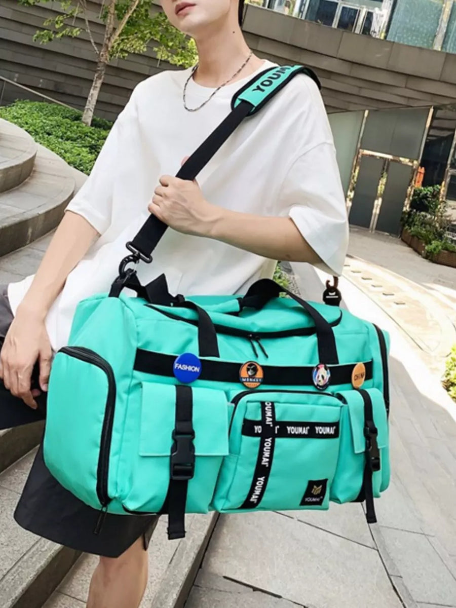 Green duffel bag with multiple pockets and black strap with text detail.