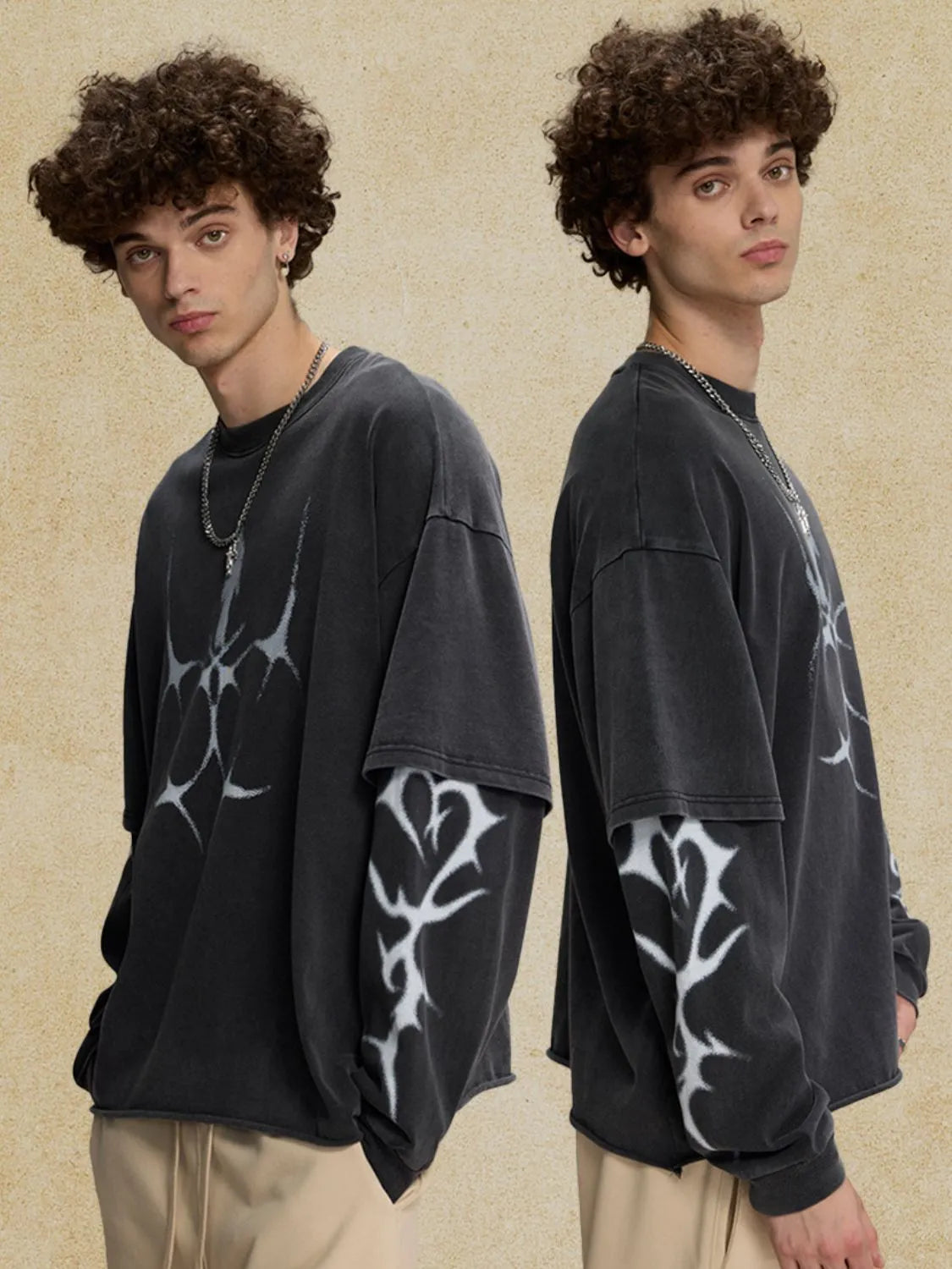 Black distressed graphic tee with layered long sleeves and abstract white print.