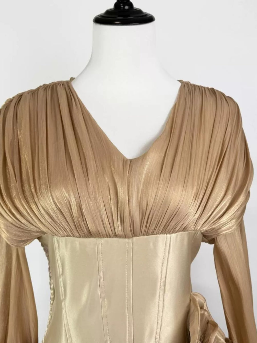 Gold ruffled mini dress with corset waist and V-neckline.