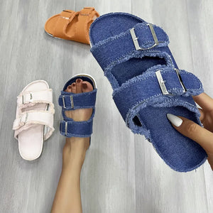 Denim frayed-edge buckle slides in blue, with a blush pink and tangerine pair visible.