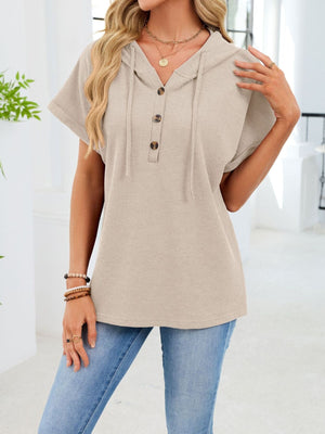 Apricot waffle knit hooded top with short sleeves and button placket.