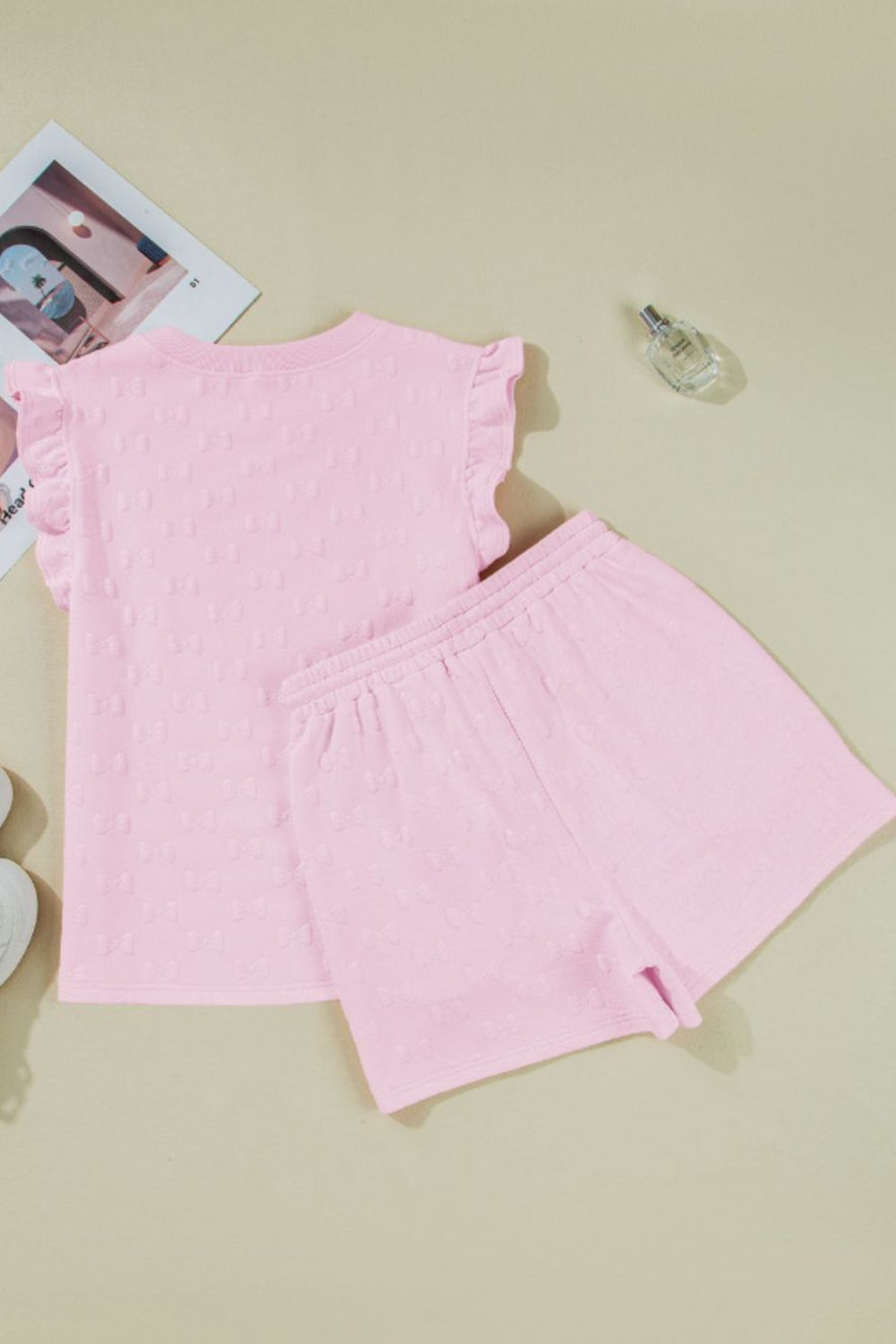 Pink bow print t-shirt with ruffled short sleeves and matching shorts