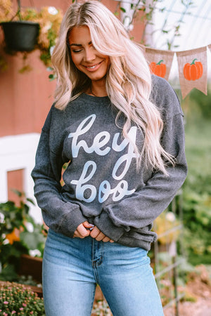 Dark gray textured sweatshirt with white "hey boo" graphic print, crewneck, long sleeves.