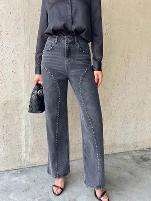 Dark gray studded high-waisted wide-leg jeans with button fly and flared hem.