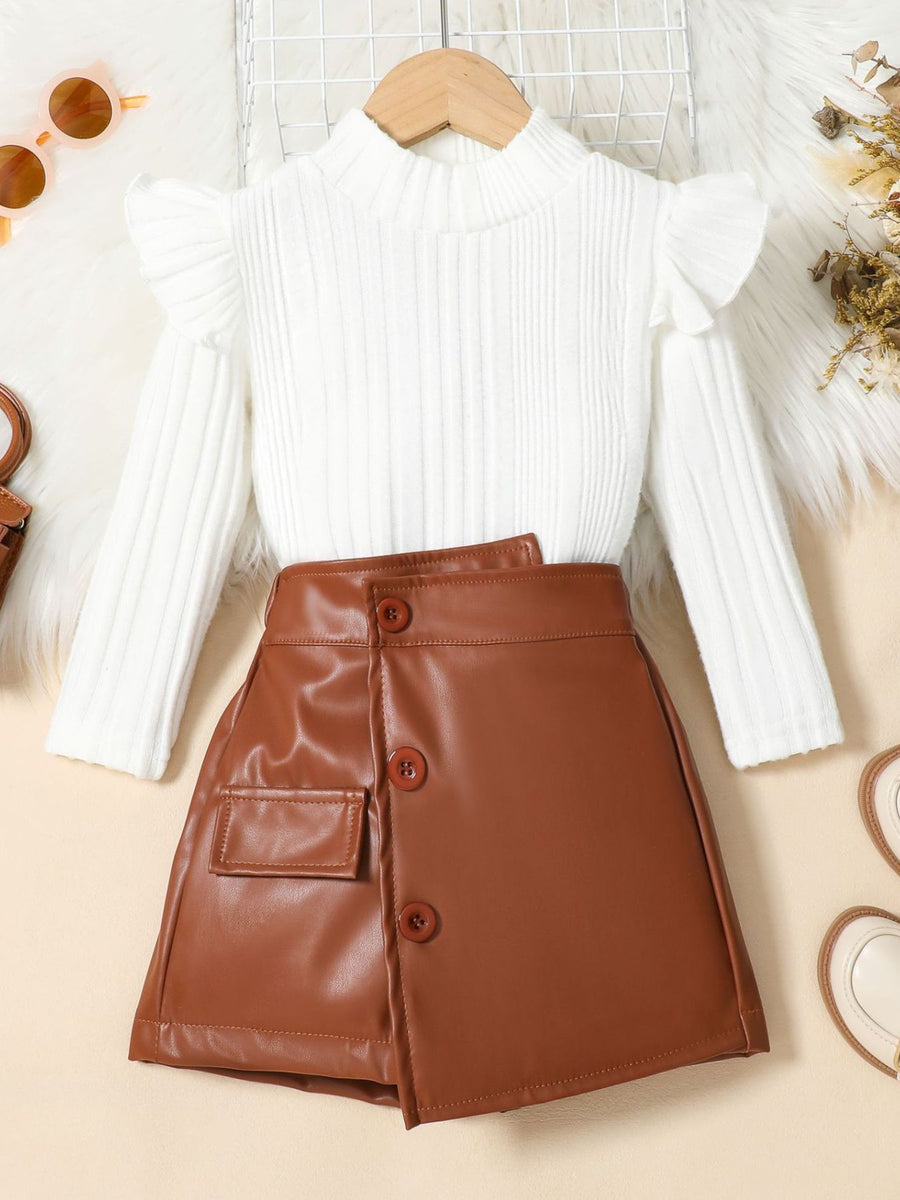 Baby ribbed knit top with ruffled shoulders and brown faux leather skirt with buttons.