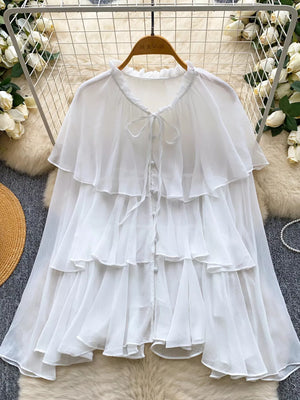 White chiffon tiered blouse with ruffled neckline and bow tie detail