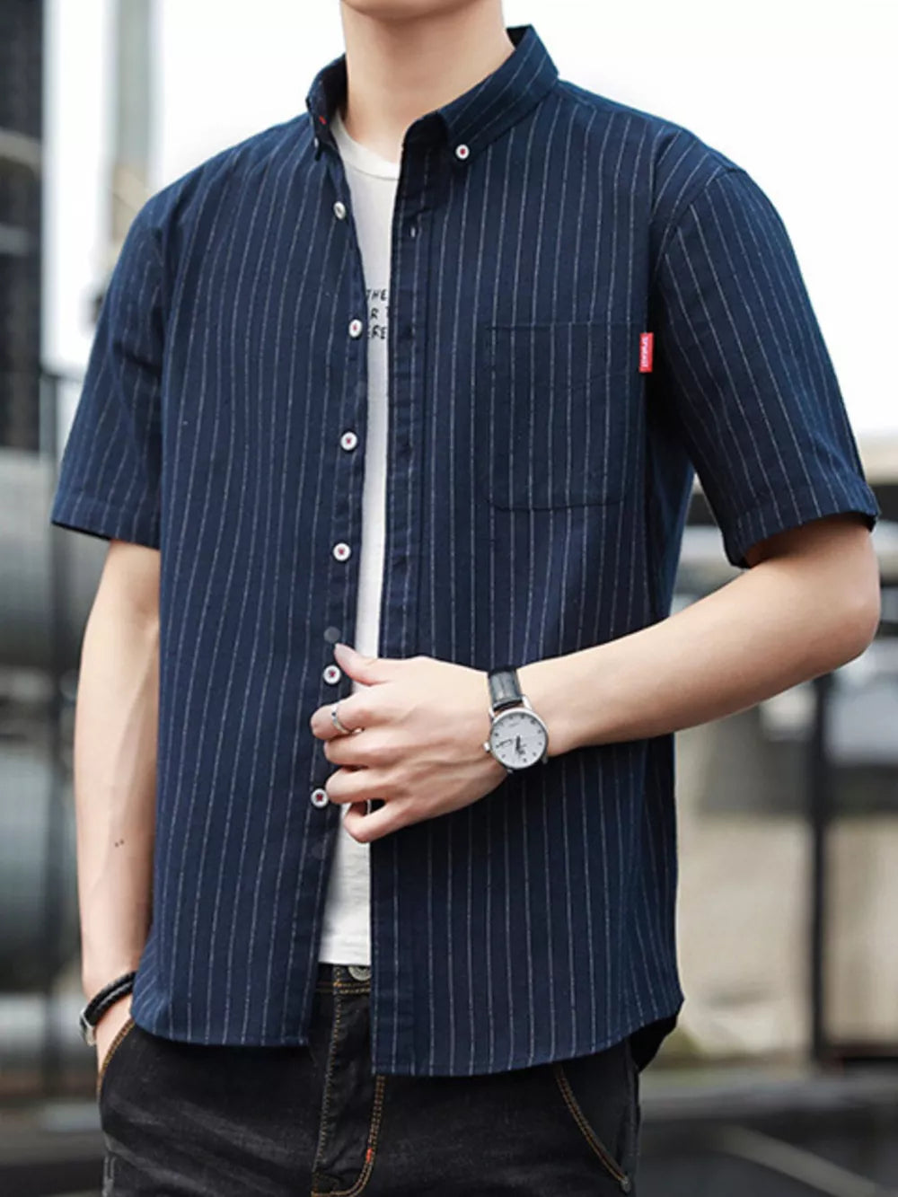 Navy blue striped short sleeve button-up shirt with a chest pocket and white undershirt.