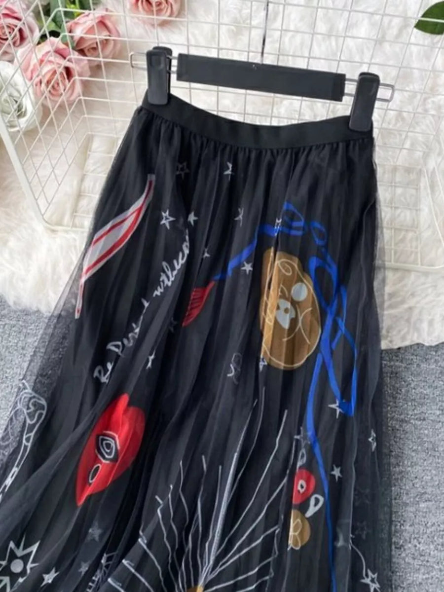 Black tulle skirt with abstract sunburst print and pleated detail.