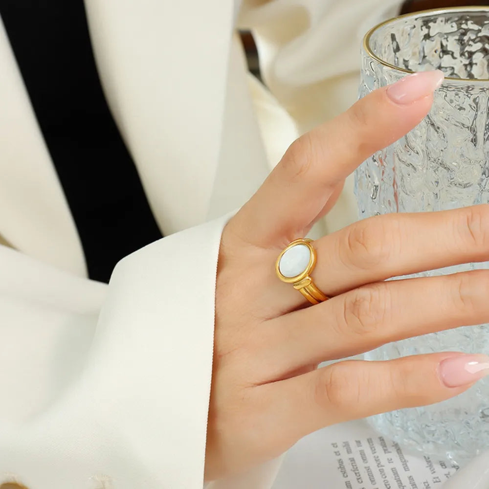Gold mother-of-pearl oval signet ring with a polished finish.
