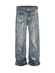 Artisan distressed wide-leg jeans in medium wash denim with paint splatters.