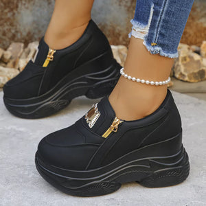 Black round toe platform sneakers with gold zipper detail and pearl ankle bracelet.