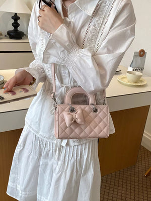 crossbody bag in blush pink featuring quilted and boxy fit