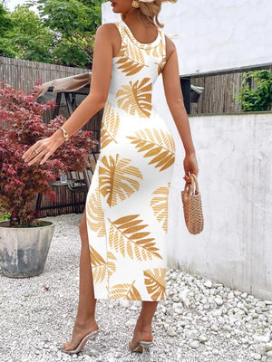 White midi dress with gold leaf print, sleeveless, side slit, and ruched detail.