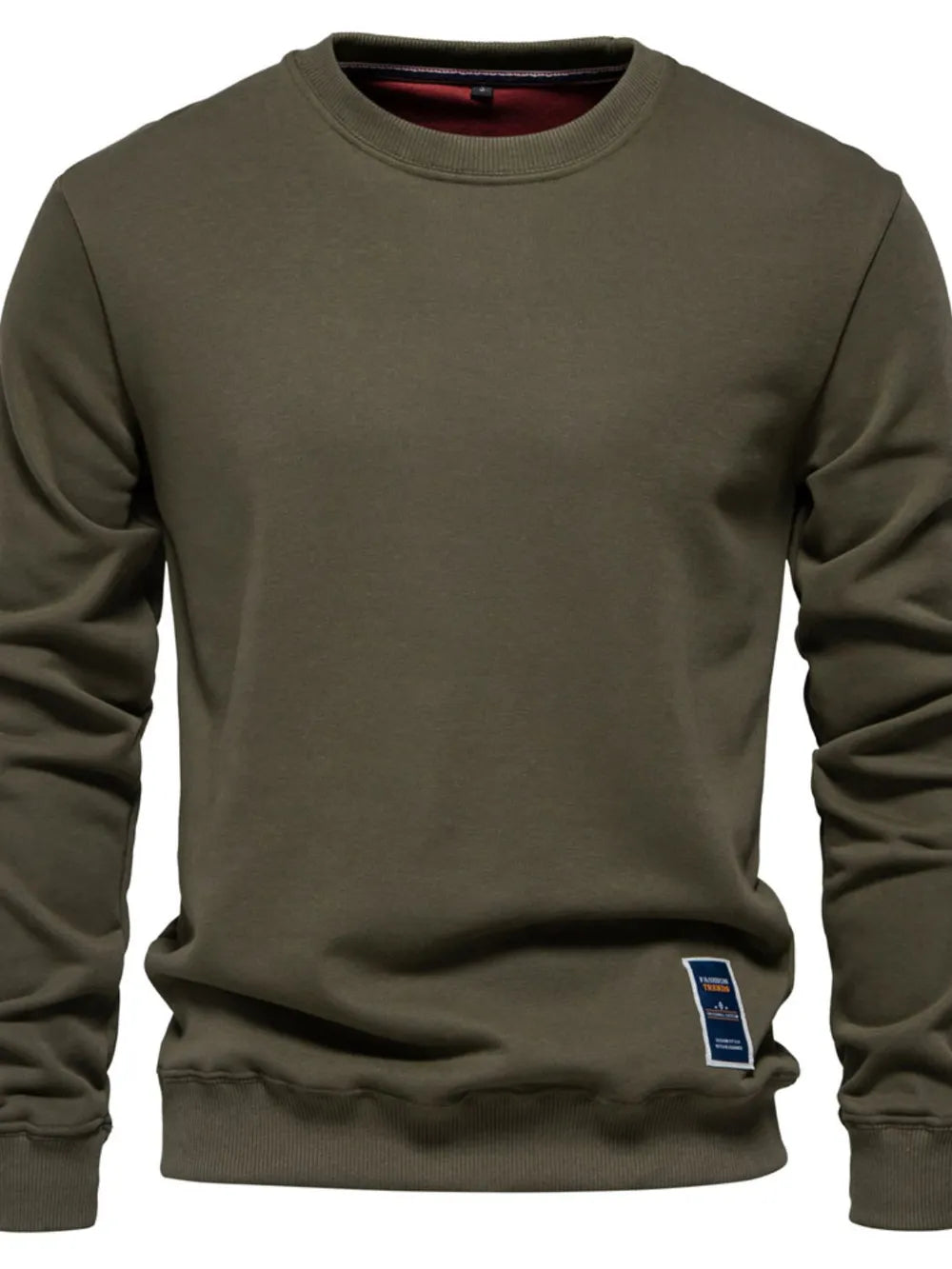Army green crewneck sweatshirt with subtle patch detail on hem