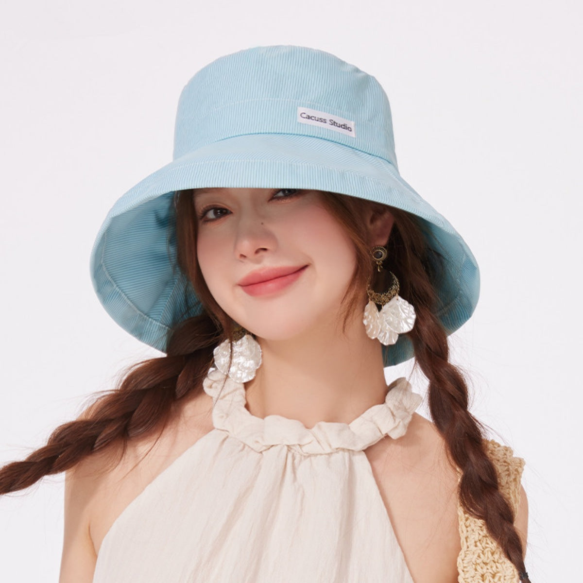 Mint green wide brim bucket hat with pinstripe detail and a small logo tag.