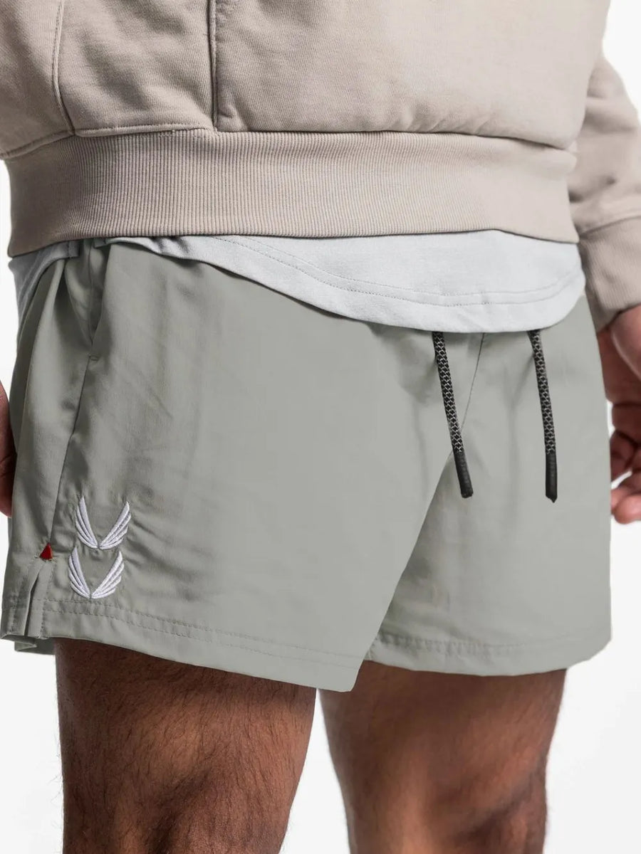 Gray performance jogger shorts with white embroidered logo and black drawcord.