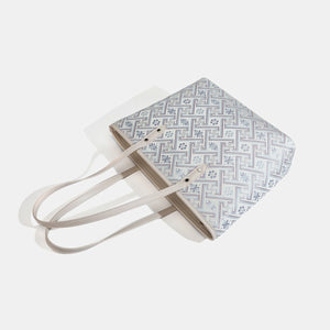 tote in light grey with geometric and tassel charm