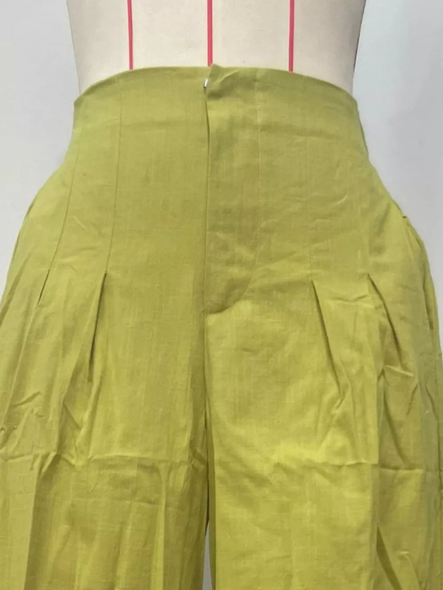 Sophisticated high-waist flowing pants in lime green with pleats and a zipper closure.