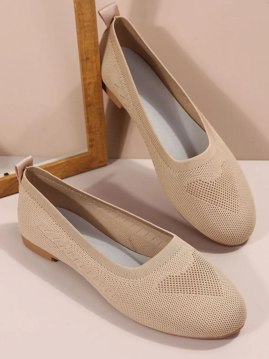 Beige knit ballet flats with subtle diamond pattern detail and pull tab.