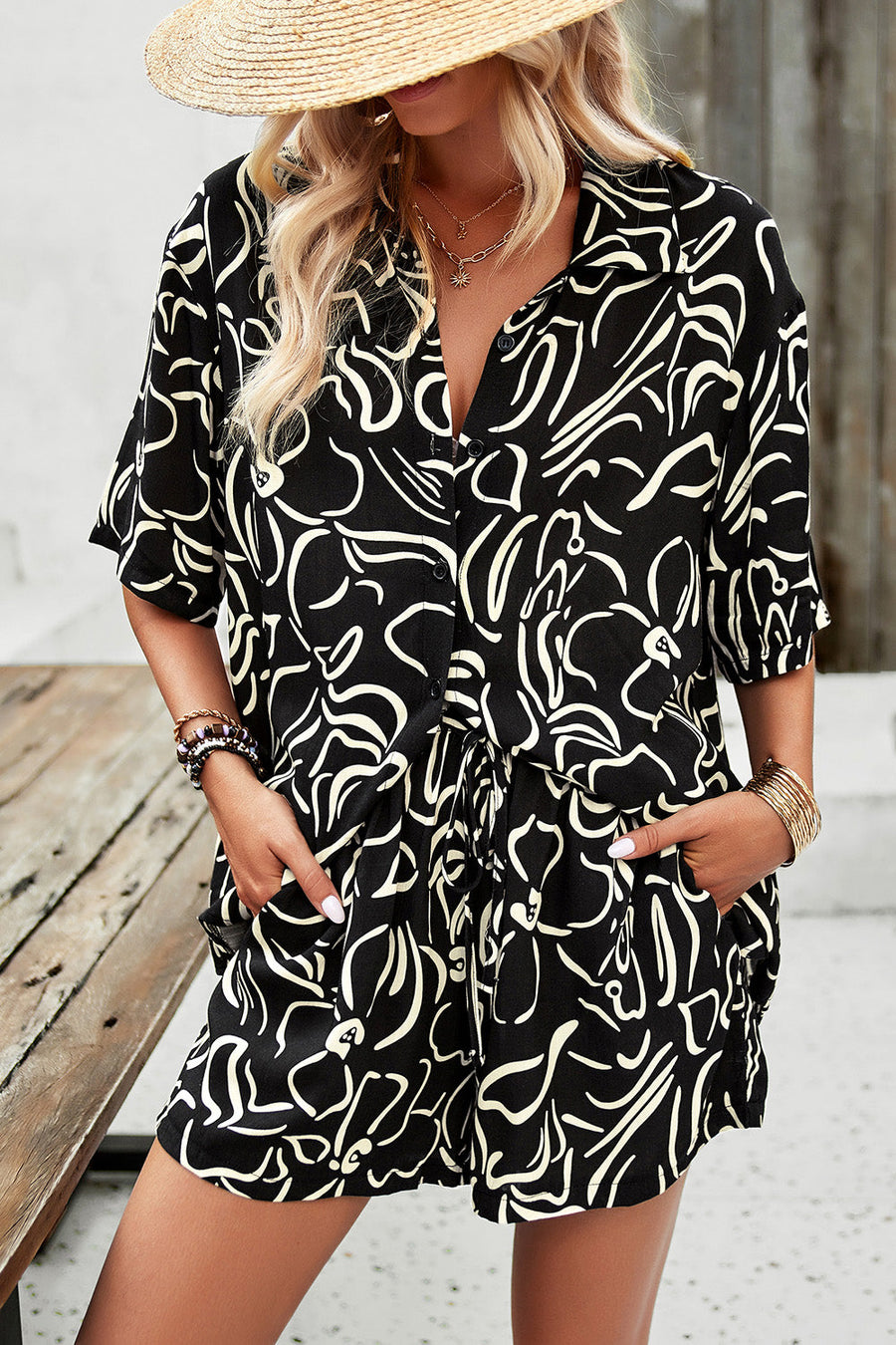 Black abstract print button-down resort shirt with short sleeves and tie waist