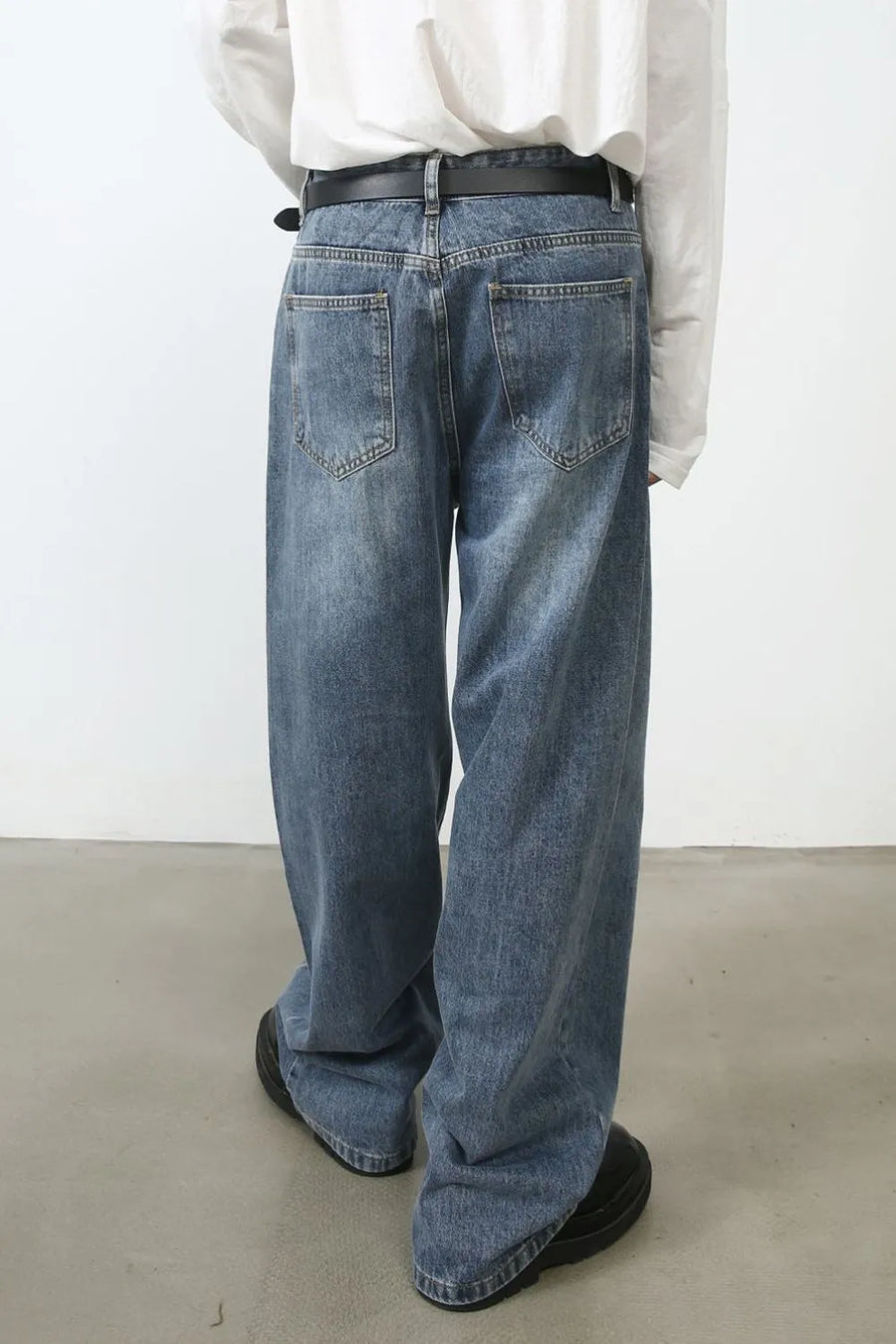 Panel seam denim jeans in medium wash with a relaxed fit.