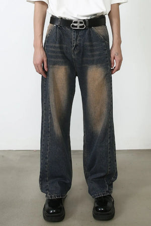 Baggy dark wash denim jeans with faded detailing and a relaxed fit.