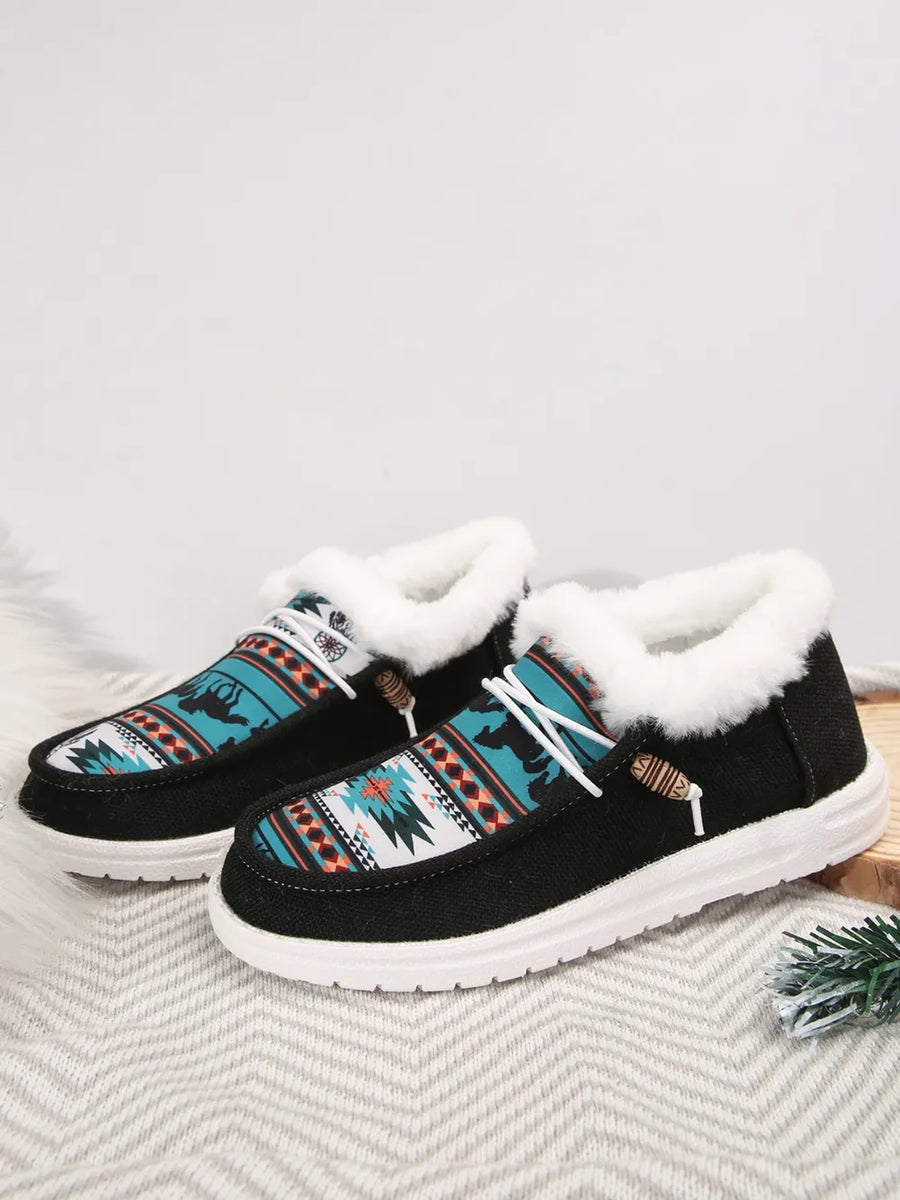 Southwestern print faux fur lined loafers in black with white laces and wooden toggles.