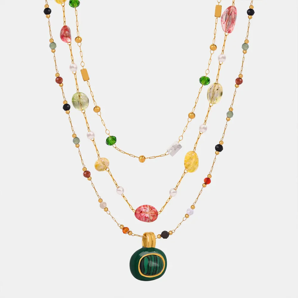 Gemstone Cascade Layered Necklace with colorful beads and a green pendant.