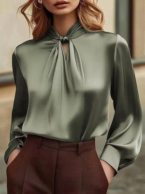 Elegant satin blouse in olive with a tie-neck and cutout detail.