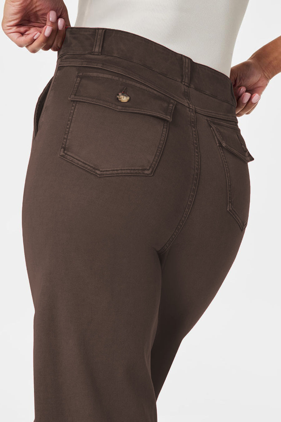 Wide-leg utility denim trousers in dark brown with buttoned flap back pockets.