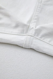 White denim jeans showing inseam and hem detail