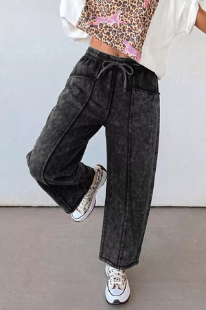 80% cotton, 20% polyester Care instructions: Machine wash cold barrel pants in charcoal gray with relaxed silhouette