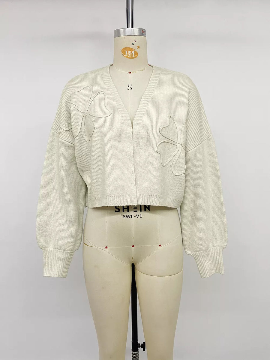 cream cardigan with four-leaf clover motif and long sleeve
