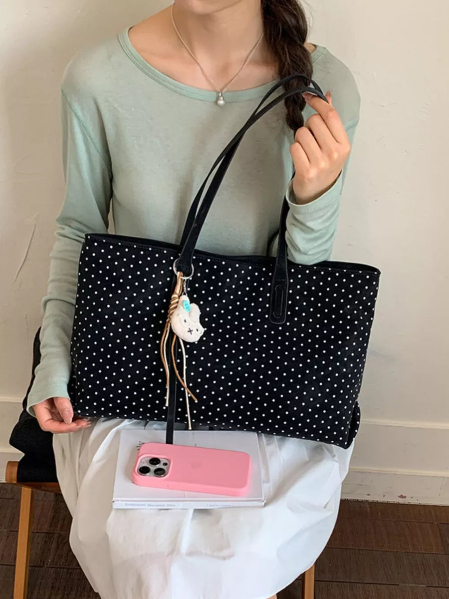handbag in black featuring shoulder straps and boxy fit