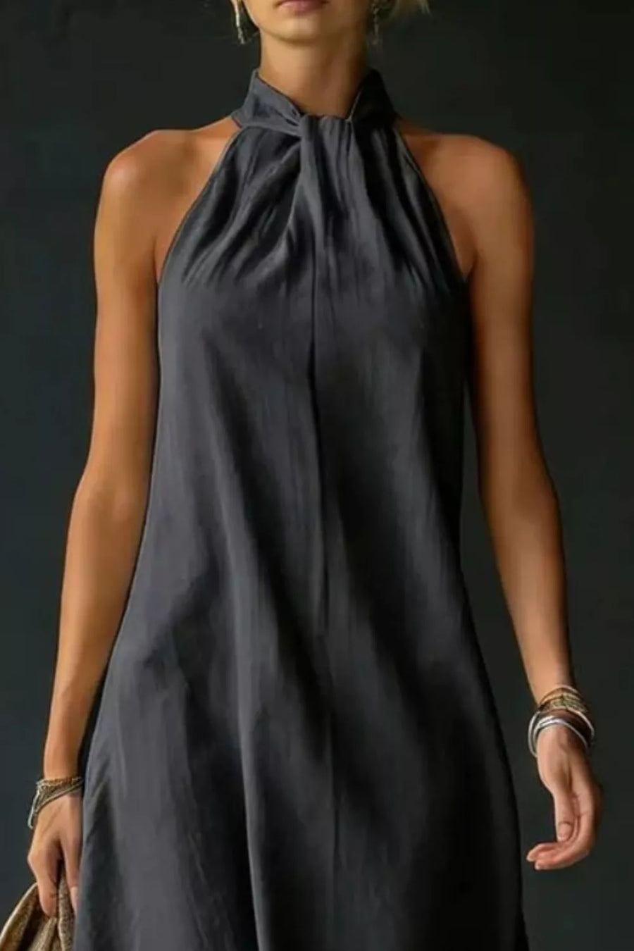 Black cotton blend maxi dress with a twisted halter neckline and a-line cut.