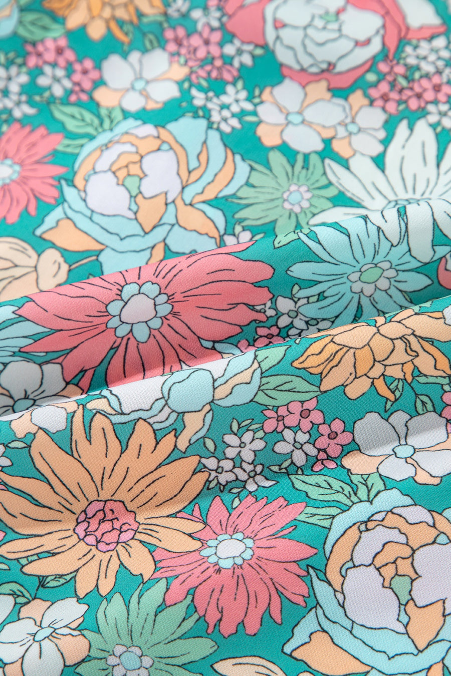 Floral peplum blouse with scallop trim in a vibrant floral print.