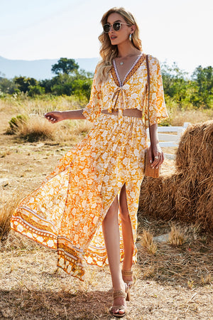 Bohemian floral crop top and maxi skirt set in tangerine with tie-front, V-neck, and high-slit skirt.