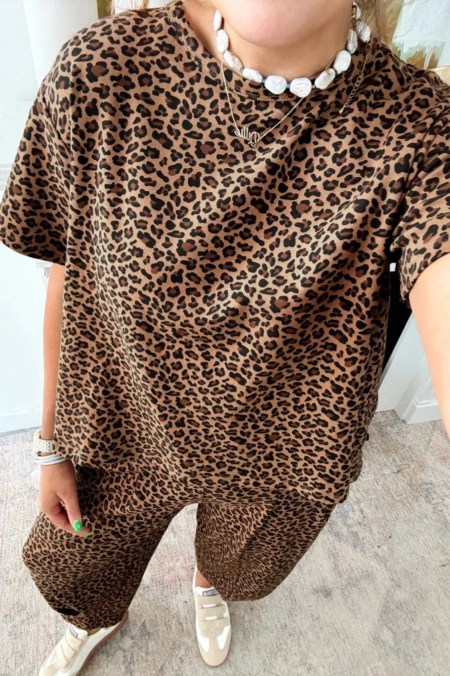 Leopard print relaxed fit two-piece set with short sleeves and wide-leg pants.