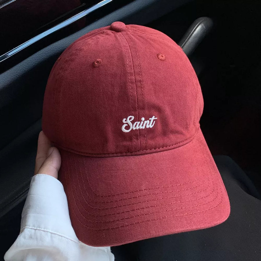 Red cotton baseball cap with white embroidered script detail