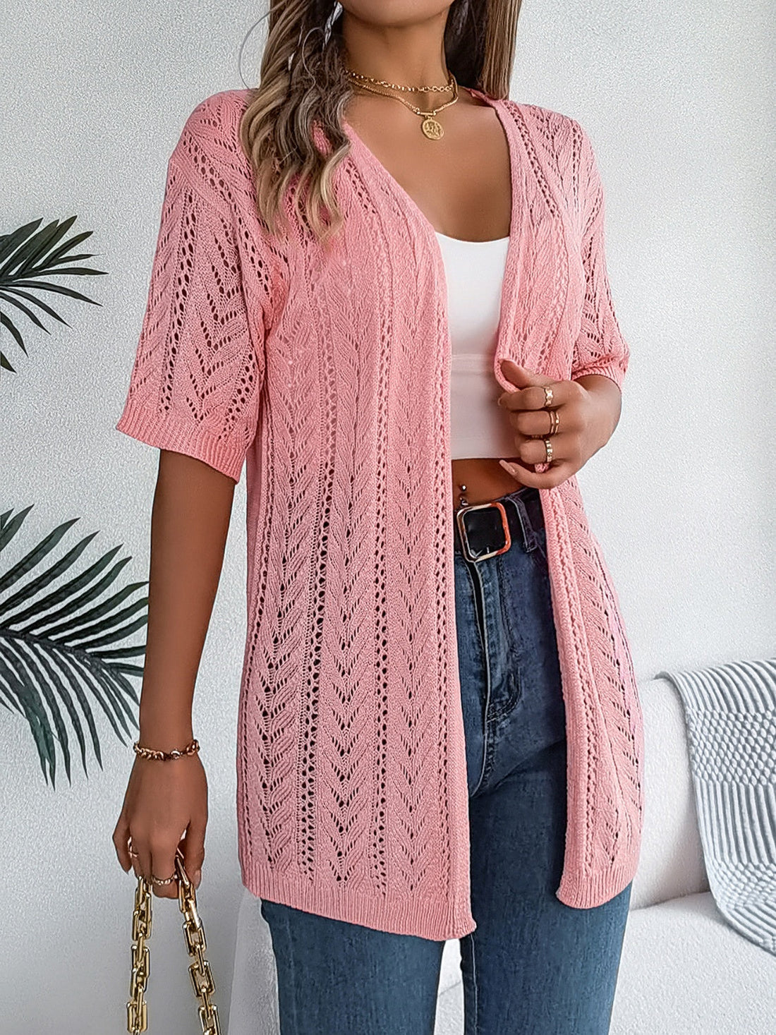 Pink open-knit chevron sleeve cardigan with V-neck and short sleeves.