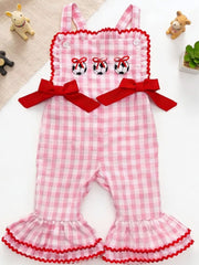 Gingham soccer ball embroidered jumpsuit in blush pink cotton with red bows and ruffled bell bottoms.