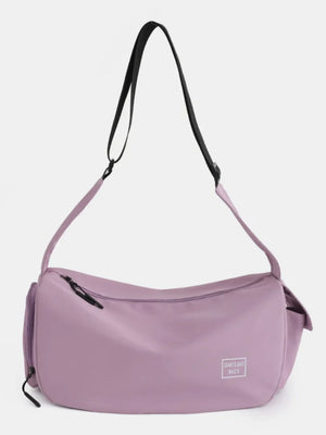 Slouchy crescent crossbody bag in Moonlit Mauve with adjustable strap and zippered pockets.