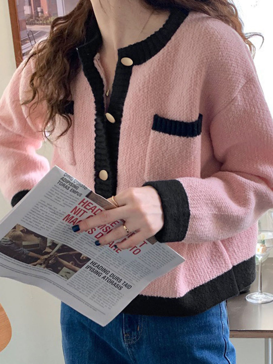 Pink acrylic button up cardigan with contrast black trim and pockets