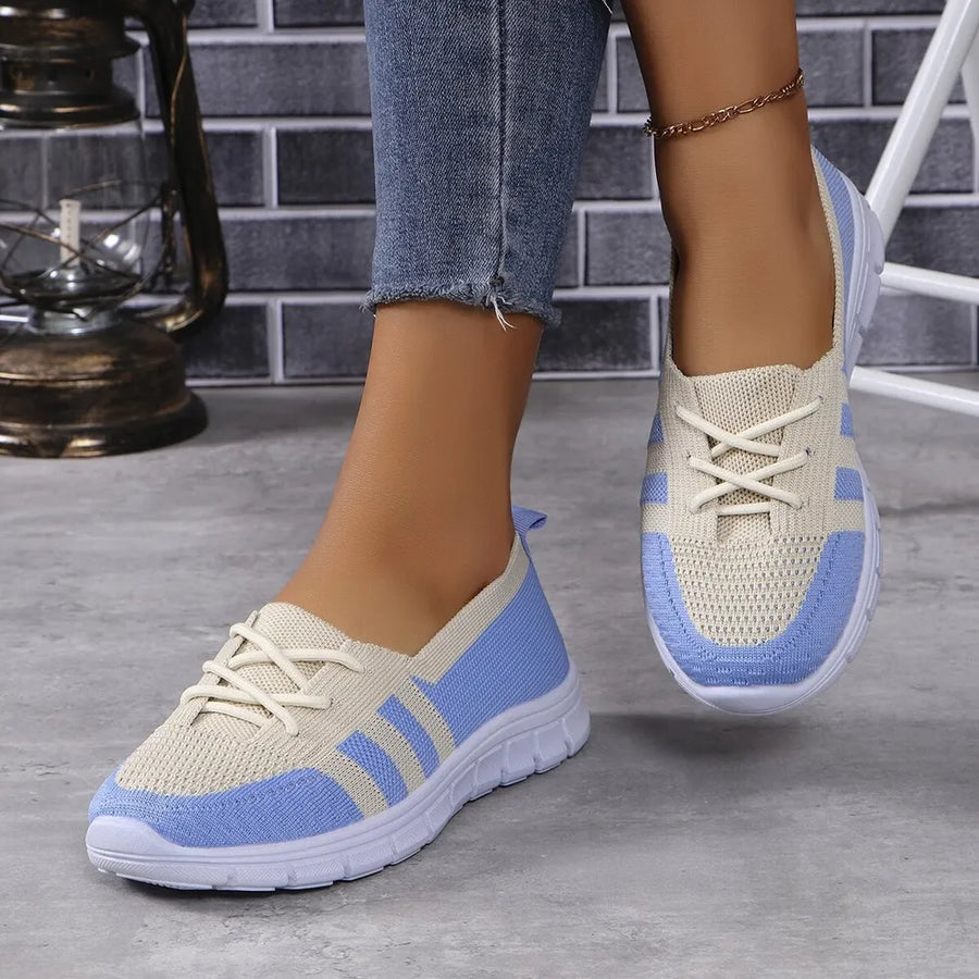 Breathable knit lace-up sneakers in beige and blue with white laces and soles.