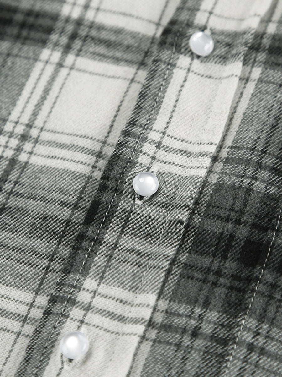 Button-up long sleeve shirt in black and white plaid cotton with pearl buttons.
