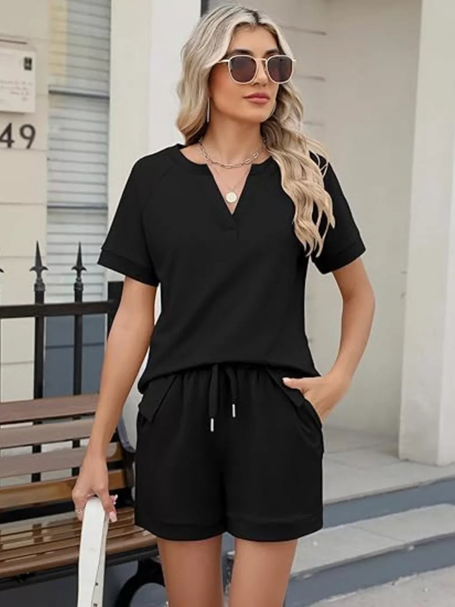 Black relaxed two-piece set with drawstring shorts and v-neck top with pockets