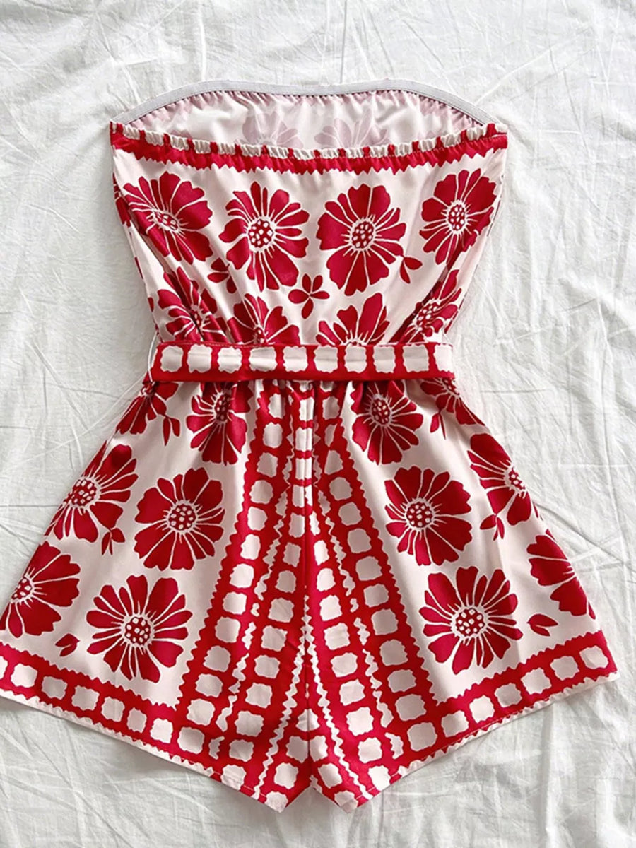 Red floral tie-waist strapless maternity romper cover-up with ruffled neckline.